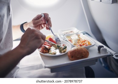 Passenger eating airline meal in airplane. Menu in business class on medium haul flight. - Powered by Shutterstock