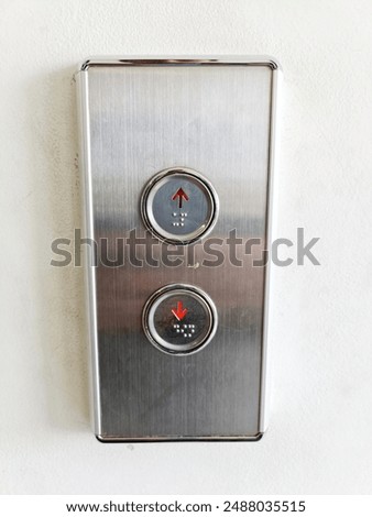 Passenger elevator buttons used to go up and down floors in a multi-storey building