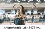 Passenger at international airport terminal for departure with airline transport. Portrait of standing tourist woman holding passport and boarding pass to transit.