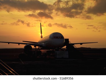 Passenger Jet On The Tarmac At Sunset In Hawaii