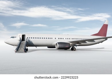 Passenger jet plane with a stairway on bright background with sky