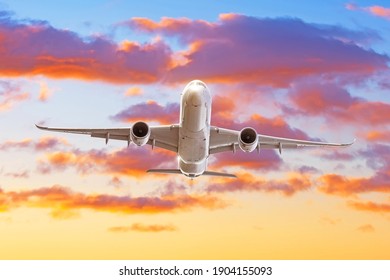 Passenger Jet Plane Take Off From Airport Runway With Beautiful Sky Clouds Light Of Sun Rising Behind