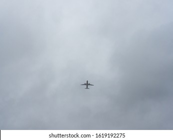 Passenger Jet Silhouette Against A Cloudy Sky