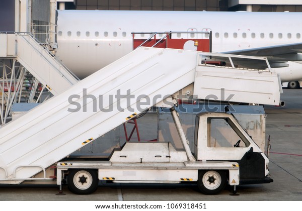 Passenger ladders for boarding\
passengers in an airplane. Airplane stairs prepared for boarding.\
