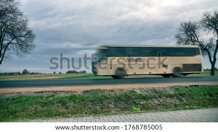 Passenger long-distance bus on the highway, Bus is blurred to make it impossible to identify brand of machine and to give dynamics to image