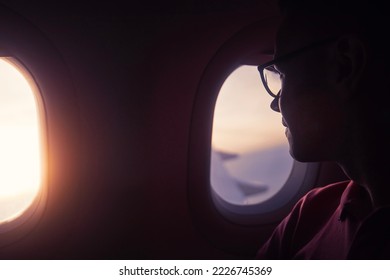 Passenger looking out through window of plane during beautiful sunset.
 - Powered by Shutterstock