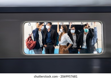 Passenger in medical face mask traveling on public transit, People in masks in mass transit with men and women, Coronavirus covid-19 healthcare medical protection. - Shutterstock ID 2069957681