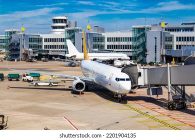 Passenger Plane At The Airport Near The Terminal Stands. The Concept Of Flight, Airport Vacation, Tickets, Passengers, Tourism, Travel, Boeing, Airbus,.aviation, Business. High Quality Photo