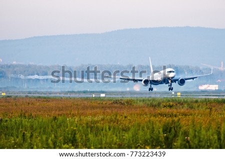 Passenger plane before touching runway landing with vortexes coming from wingtips