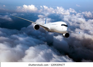 Passenger plane in flight. Aircraft fly high in the sky above the clouds. Front view of airplane.