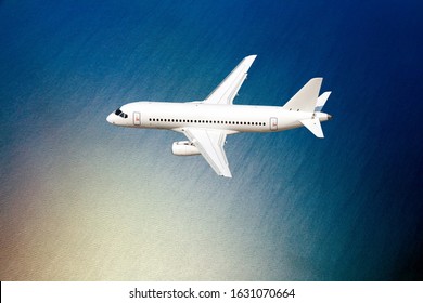 Passenger Plane In Flight. A Plane Makes A Transatlantic Flight Over The Ocean.