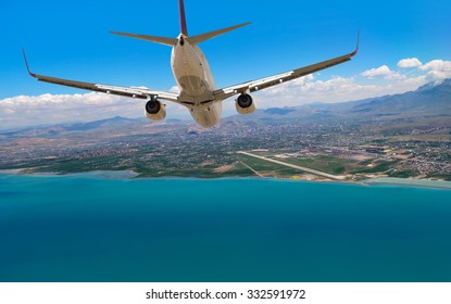 passenger plane fly down over take-off runway from airport