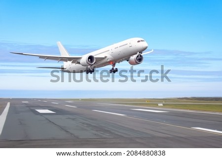 Passenger plane jet fly up over take off runway from airport