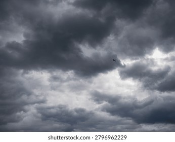 Passenger plane over a clouded and dramatic sky