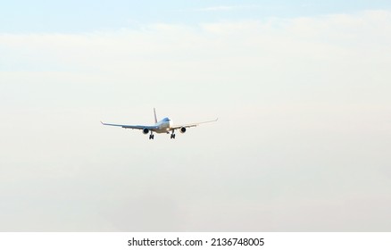 Passenger plane over the forest in the blue sky, the sun is shining. Transport, travel. High quality photo - Shutterstock ID 2136748005