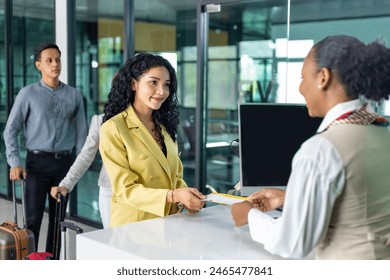 Passenger is receiving boarding pass from the airline ground crew at departure gate into the airplane for flight check in before boarding into plane - Powered by Shutterstock