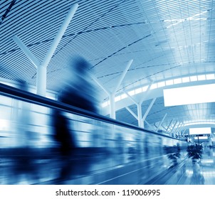 passenger rushing through an escalator in airport terminal - Powered by Shutterstock