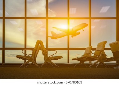 passenger seat in Departure lounge for see Airplane, view from airport terminal.sun light in vintage color selective focus,transport and travel concept - Powered by Shutterstock