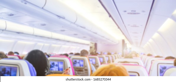 passenger seat, Interior of airplane with passengers sitting. cabin of airplane with passengers on seats waiting to take off. Blurred picture.