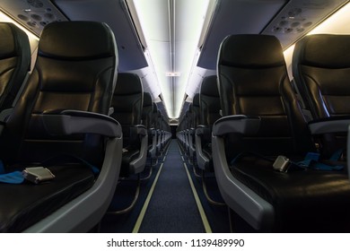 Passenger seats, Interior of airplane with the aisle and empty seats. Travel concept.