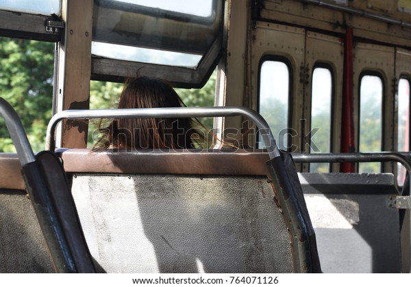 Passenger\
sitting on seat in public bus\
transportation