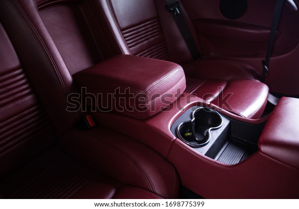 Passenger storage compartment in red leather\
car interior	\
