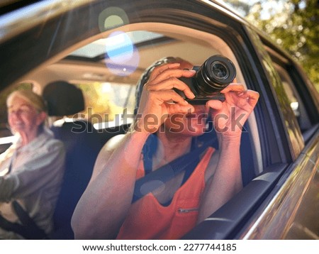 Similar – Image, Stock Photo Woman looking through the binoculars and friend driving