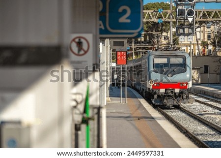 Similar – Image, Stock Photo Passenger train is arrived to railway platform station, people walking in hurry, Sun in backlight