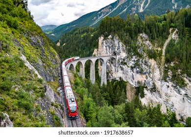 Passenger Train Crossing The Landwasser Viaduct In The Swiss Alps