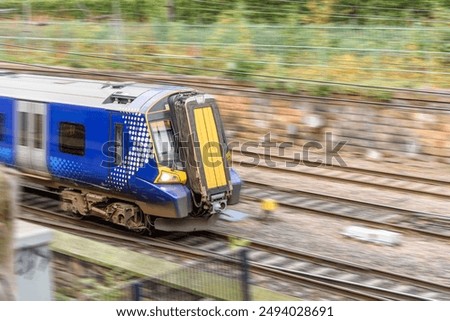 Passenger train fast moving while approaching a train station station