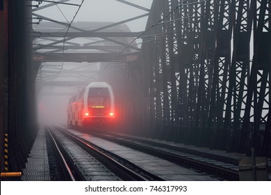 Passenger Train On The Old Iron Bridge In Mysterious Fog - Blurred Motion