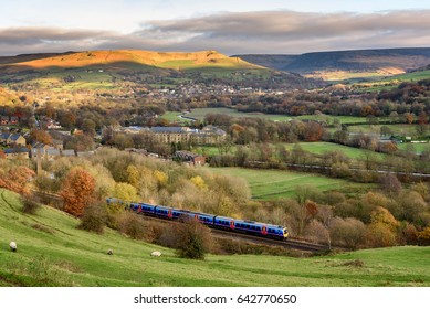 Passenger Train Passing Through British Countryside Near Greater Manchester, England.