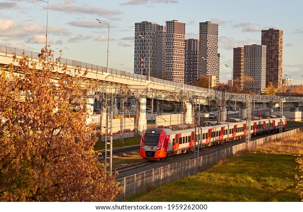 Passenger\
transportation on the background of modern buildings and road\
overpasses - Moscow, Russia, October 15,\
2020