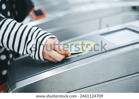 Passenger Using Contactless Payment at Subway Turnstile