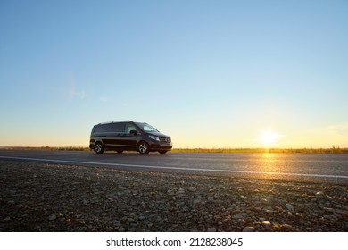 Passenger Van Driving Fast On Intercity Road At Sunset. Highway Traffic In Evening. Kyiv, Ukraine - October 12, 2021.