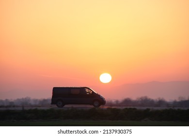 Passenger Van Driving Fast On Intercity Road At Sunset. Highway Traffic In Evening. Kyiv, Ukraine - October 12, 2021.