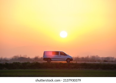 Passenger Van Driving Fast On Intercity Road At Sunset. Highway Traffic In Evening. Kyiv, Ukraine - October 12, 2021.