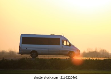 Passenger Van Driving Fast On Intercity Road At Sunset. Highway Traffic In Evening. Kyiv, Ukraine - October 12, 2021.