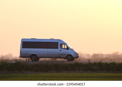 Passenger Van Driving Fast On Intercity Road At Sunset. Highway Traffic In Evening. Kyiv, Ukraine - October 12, 2021.