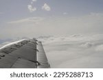 passenger view out of a historical Junkers Ju-52 plane with clouds in background
