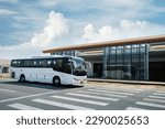 The passenger white bus is parking  near airport.  bus transport, tourism transportation, travel concept.