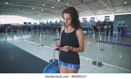 Passenger, woman in the airport, waiting for her flight checking her passport and documents already missing the careless time of holidays.