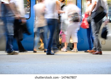 Passengers about to enter train, motion blur