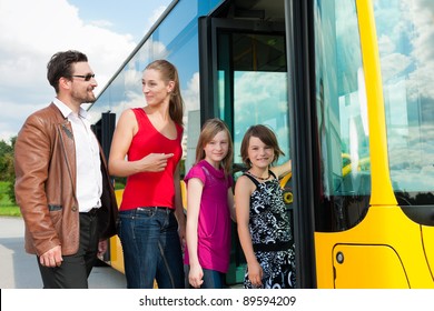 Passengers Boarding A Bus At A Bus Station