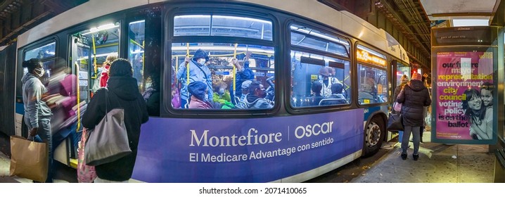 Passengers In Coats Entering The Doors In MTA Bus On A Bus Stop At Night, White Plains Road And Pelham Parkway, New York, Very Wide Shoot Panorama,  Bronx, United States Of America, 11.08.2021