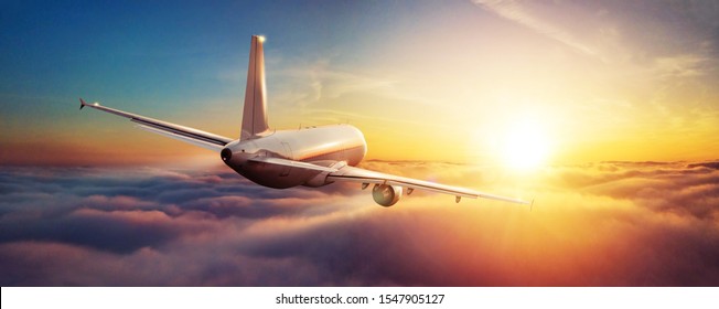 Passengers commercial airplane flying above clouds in sunset light. Concept of fast travel, holidays and business. - Shutterstock ID 1547905127