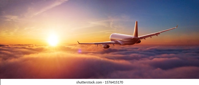 Passengers commercial airplane flying above clouds in sunset light. Concept of fast travel, holidays and business. - Shutterstock ID 1576415170