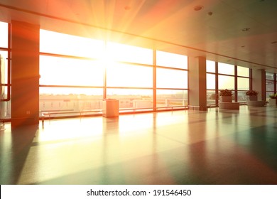 Passengers In Modern Airport Interior Glass Wall Aisle Windows Of People