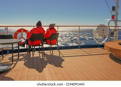 Passengers On An Antarctic Expedition At The Stern Of A Ship In Sunshine