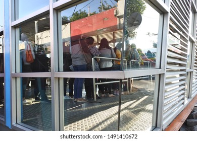 Passengers Queued To Board The Transjakarta Bus, Kalideres Bus Terminal, West Jakarta. Indonesia, August 23, 2019